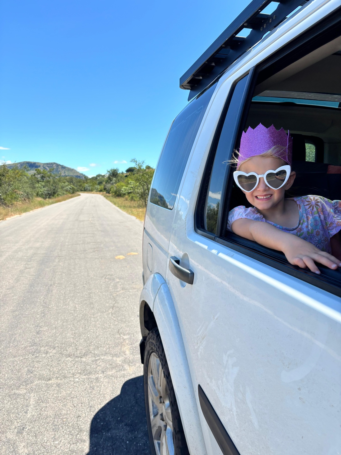 Happy child on a road trip with an activity booklet